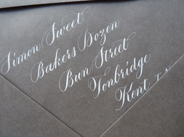 white-copperplate-calligraphy-on-gray-envelope-uk