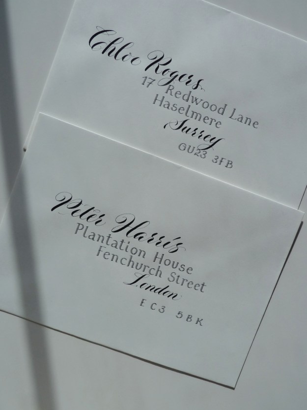 contrasting-calligraphy-styles-black-ink-on-white-envelopes