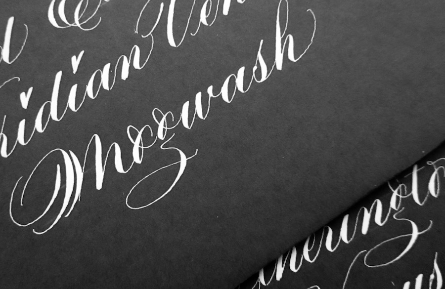 white-calligraphy-on-grey-envelopes