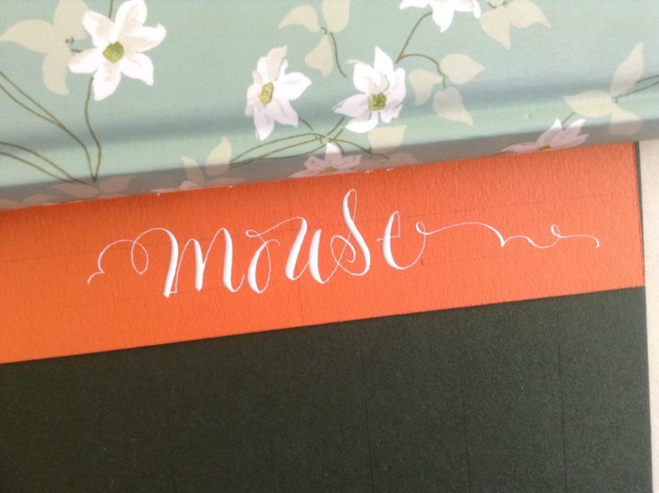 white-modern-calligraphy-on-bright-orange-paper