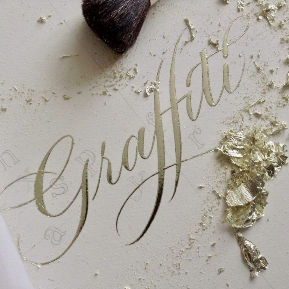 gilding the word graffiti work in progress with real loose leaf gold
